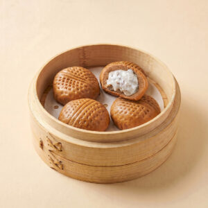 Close-up shot of hot chocolate walnut steamed bao bun showing white chocolate and walnut filling