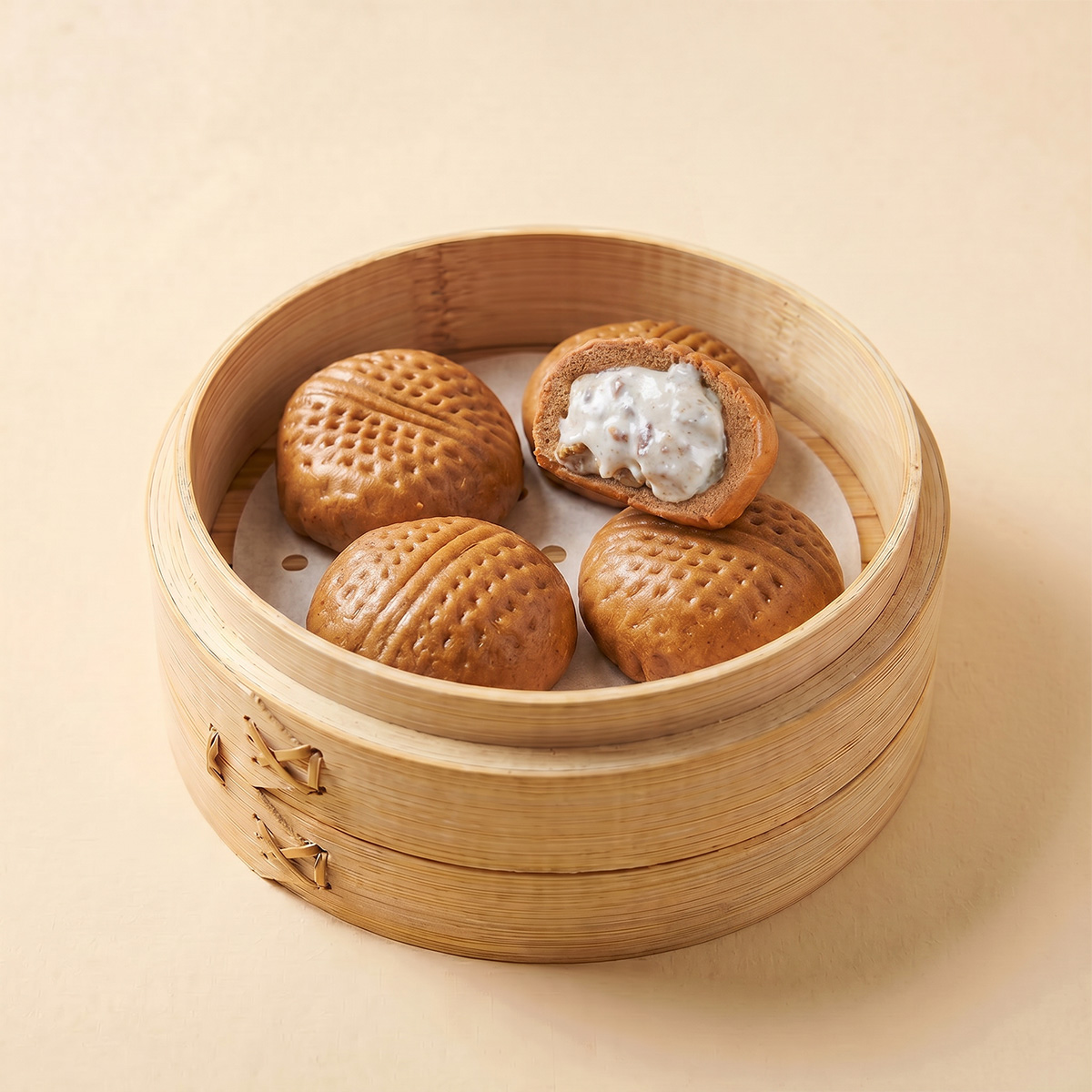 Close-up shot of hot chocolate walnut steamed bao bun showing white chocolate and walnut filling