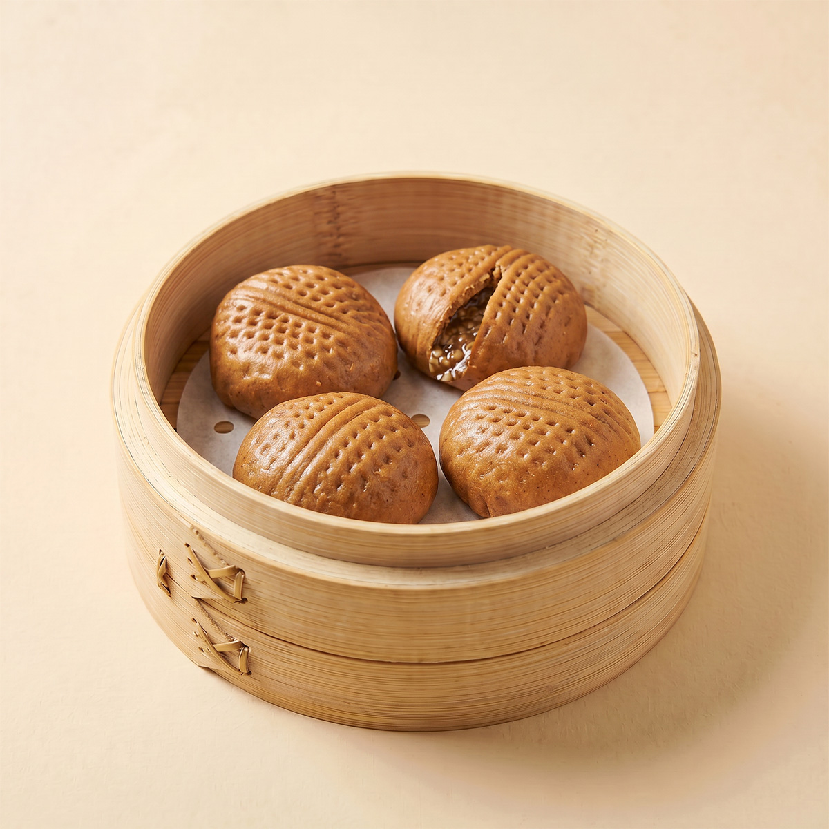 Close-up shot of steaming hot oatmeal walnut steamed bao bun showing crushed walnut filling