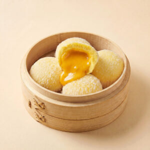 Close-up shot of hot molten flowing filling inside golden salted egg custard lava bun liu sha bao