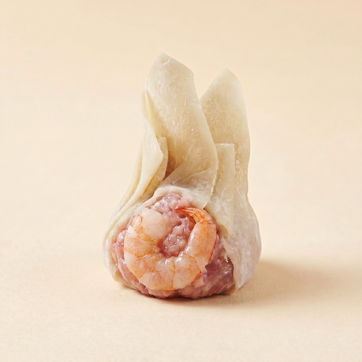 Close-up shot of steaming hot authentic Cantonese shrimp and pork wonton showing translucent wrapper and whole shrimp filling