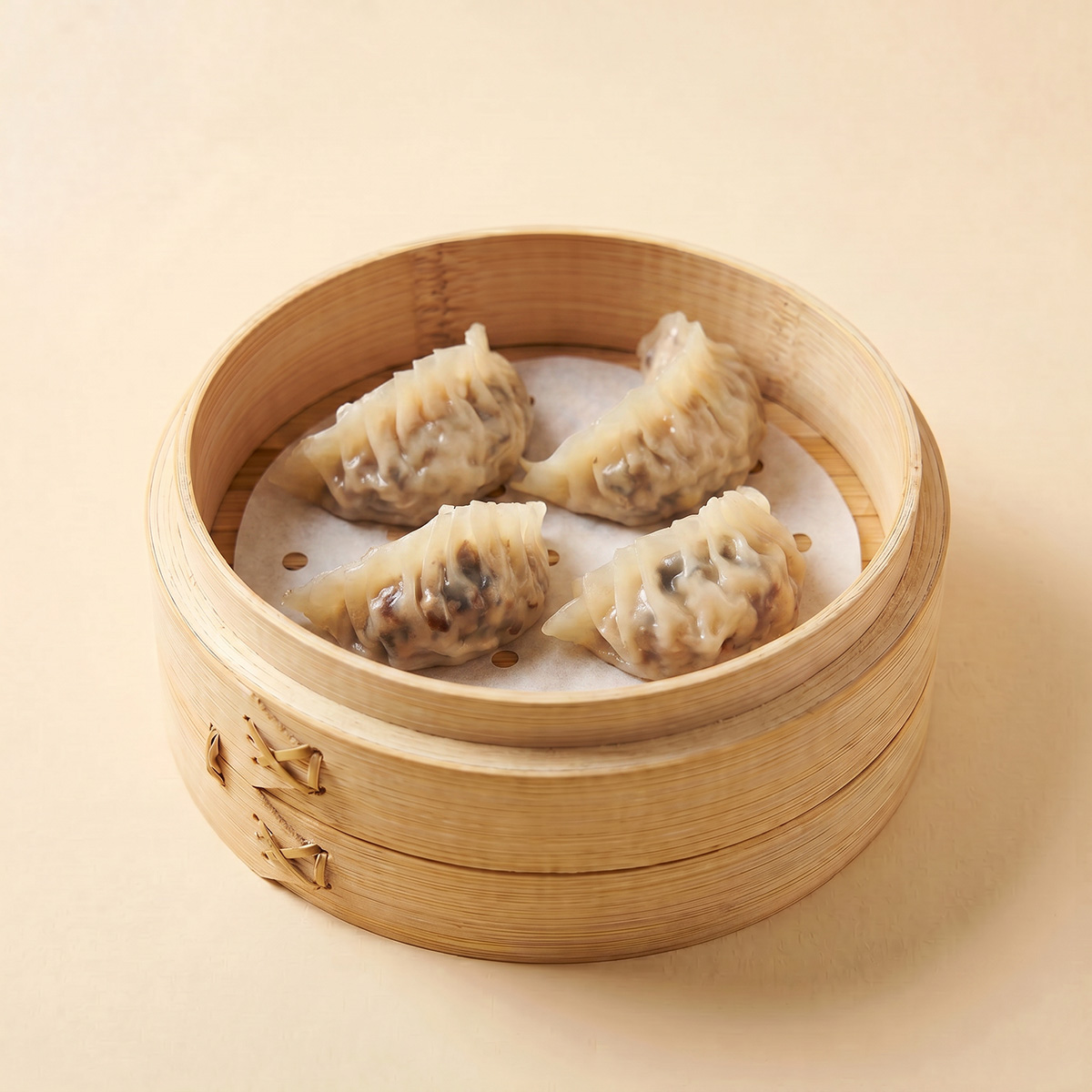 Close-up shot of a boiled shiitake mushroom and pork dumpling sliced open showing diced mushrooms and water chestnuts
