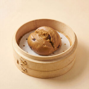 Close-up shot of steaming hot brown sugar steamed bao bun brown sugar mantou showing soft texture