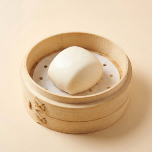 Close-up shot of steaming hot plain steamed bao bun white mantou showing fluffy texture